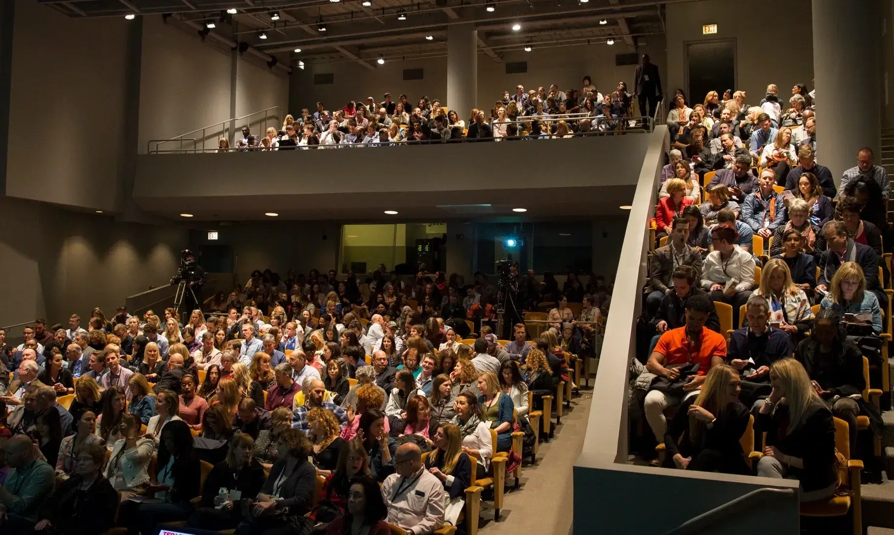 Audience seated in a large auditorium.