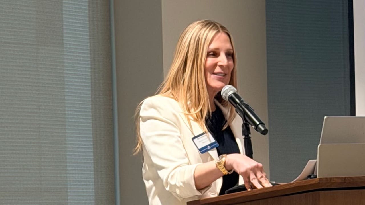 Woman speaking at podium with microphone